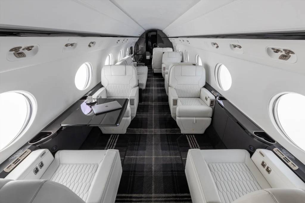 Luxury charter flights cabin with sleek white leather seats and elegant interior design.