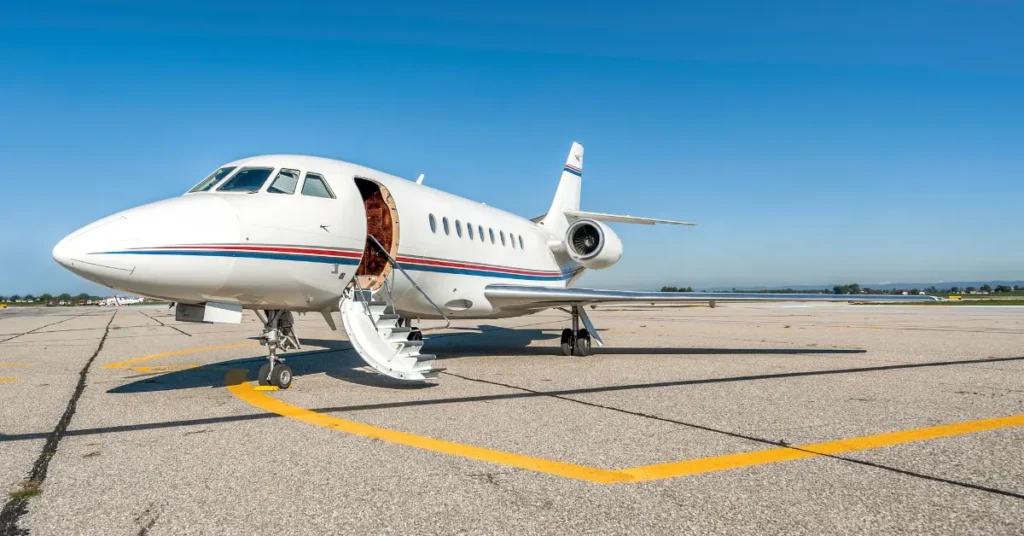 Charter jet services aircraft parked on a runway with open cabin door and visible stairs