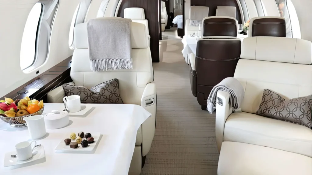 Private plane charter cabin with leather seats, gourmet snacks, and plush decor.