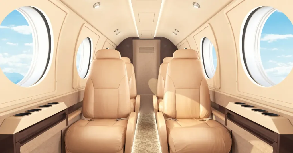 Empty leg flight deals shown in a bright, leather-seated private jet cabin with window views.