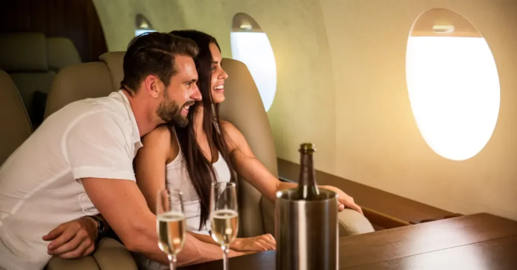 Private flight service featuring a couple enjoying champagne in a luxury jet cabin.